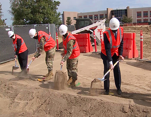 People digging on site for ground breaking of new facility