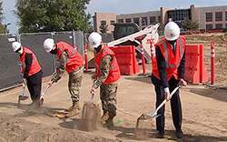 People digging on site for ground breaking of new facility