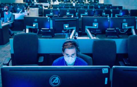 Launch control room with socially distant people with masks