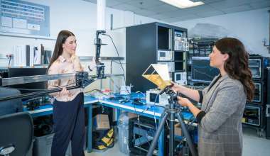 Two women having a discussion in a lab.