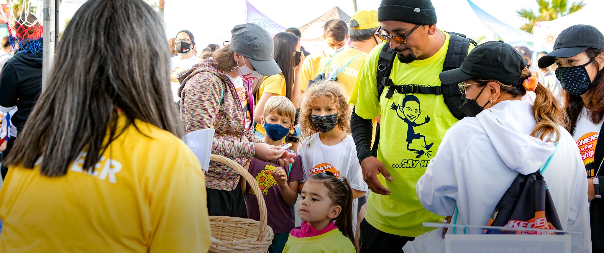 Christine Kato engaging with booth visitors at Skechers Pier to Pier Friendship Walk 2021