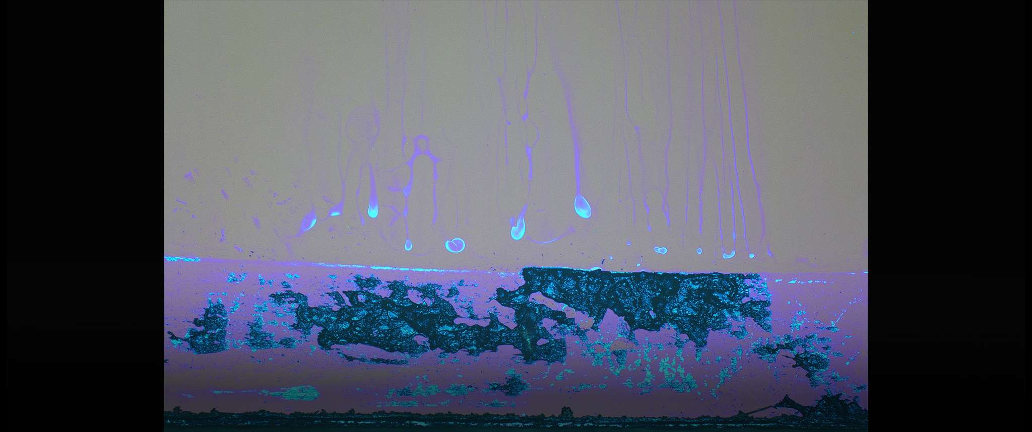 Impressionist Contamination Drips: Unknown cleaning residue left on substrate is imaged with Nikon microscope. The robust contamination control program at Aerospace plays a key role in mitigating contamination effects on performance degradation of space systems such as optics, solar arrays, and thermal control systems.